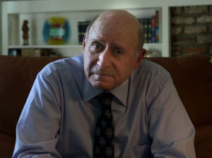 Dr. Scott Abramson, MD, sitting on a couch in his home